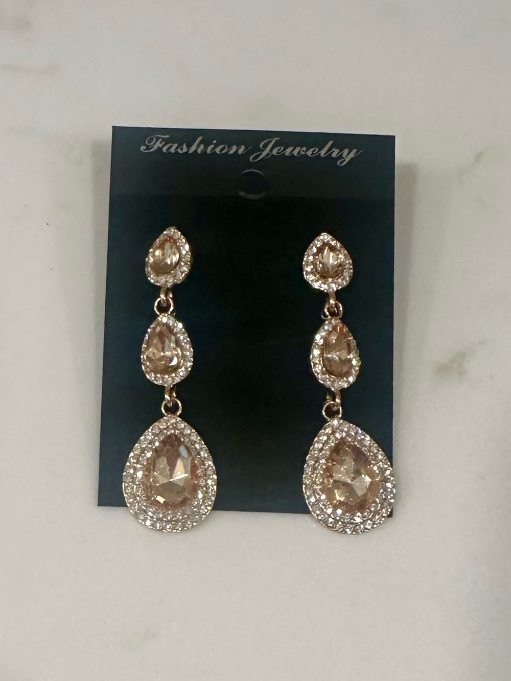 Gold Tone Teardrop Dangle Earrings with Champagne Stones
